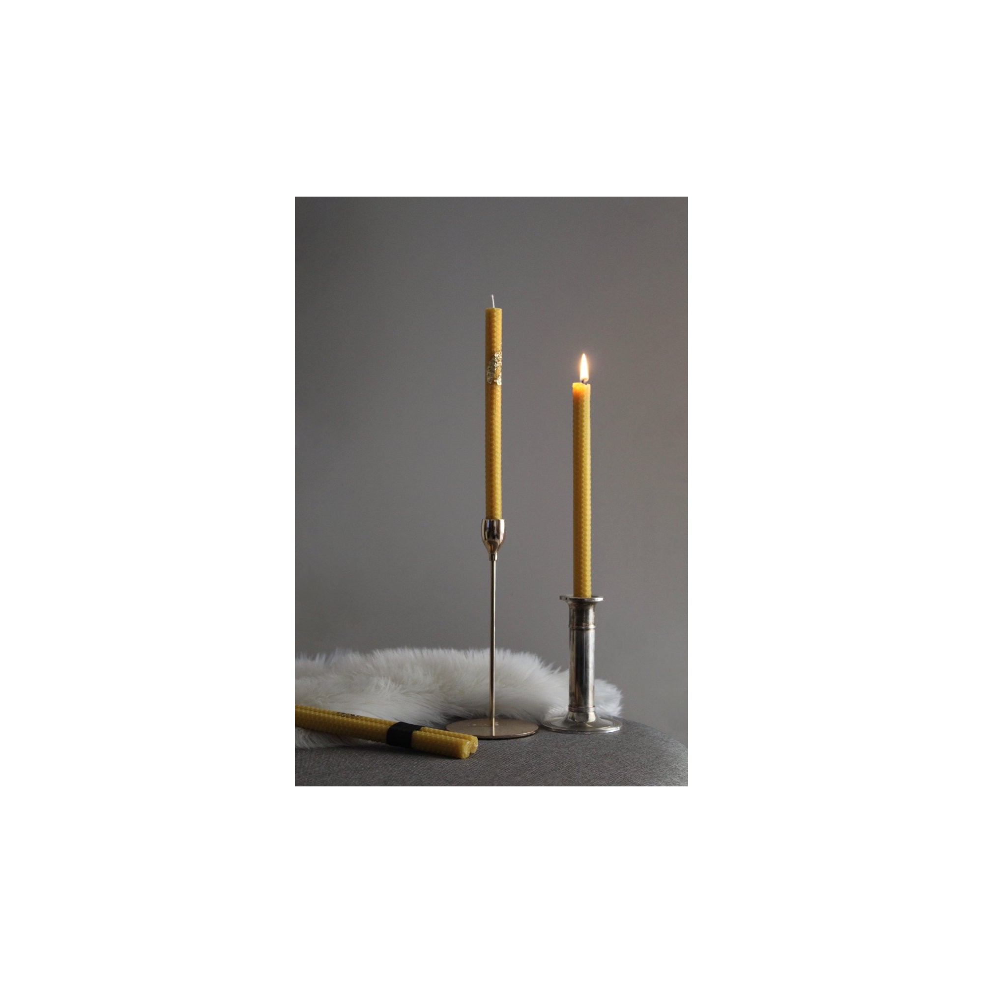 Honeycomb beeswax candles placed in candle holders MELICERA, front view