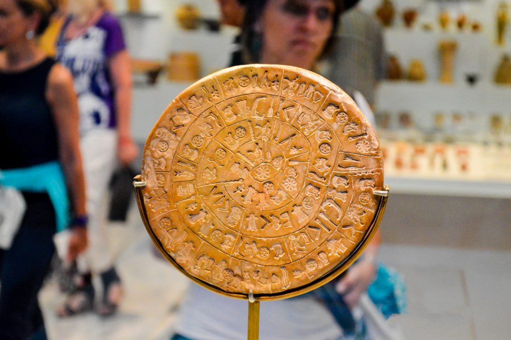 The Phaistos Disc, a disk of fired clay from the Minoan Palace of Phaistos exposed at Heraklion Archeological Museum in Crete, Greece.