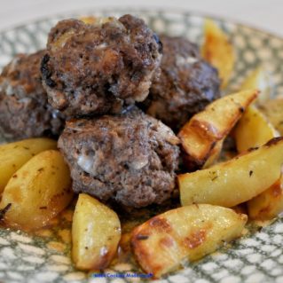 Baked Biftekia with potatoes and lemon