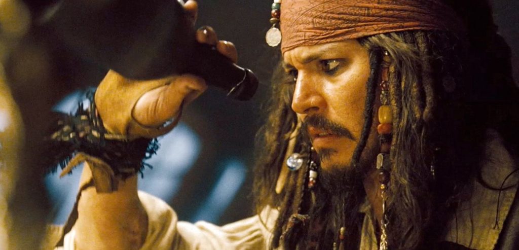 Jack sparrow looking at a rhum bottle