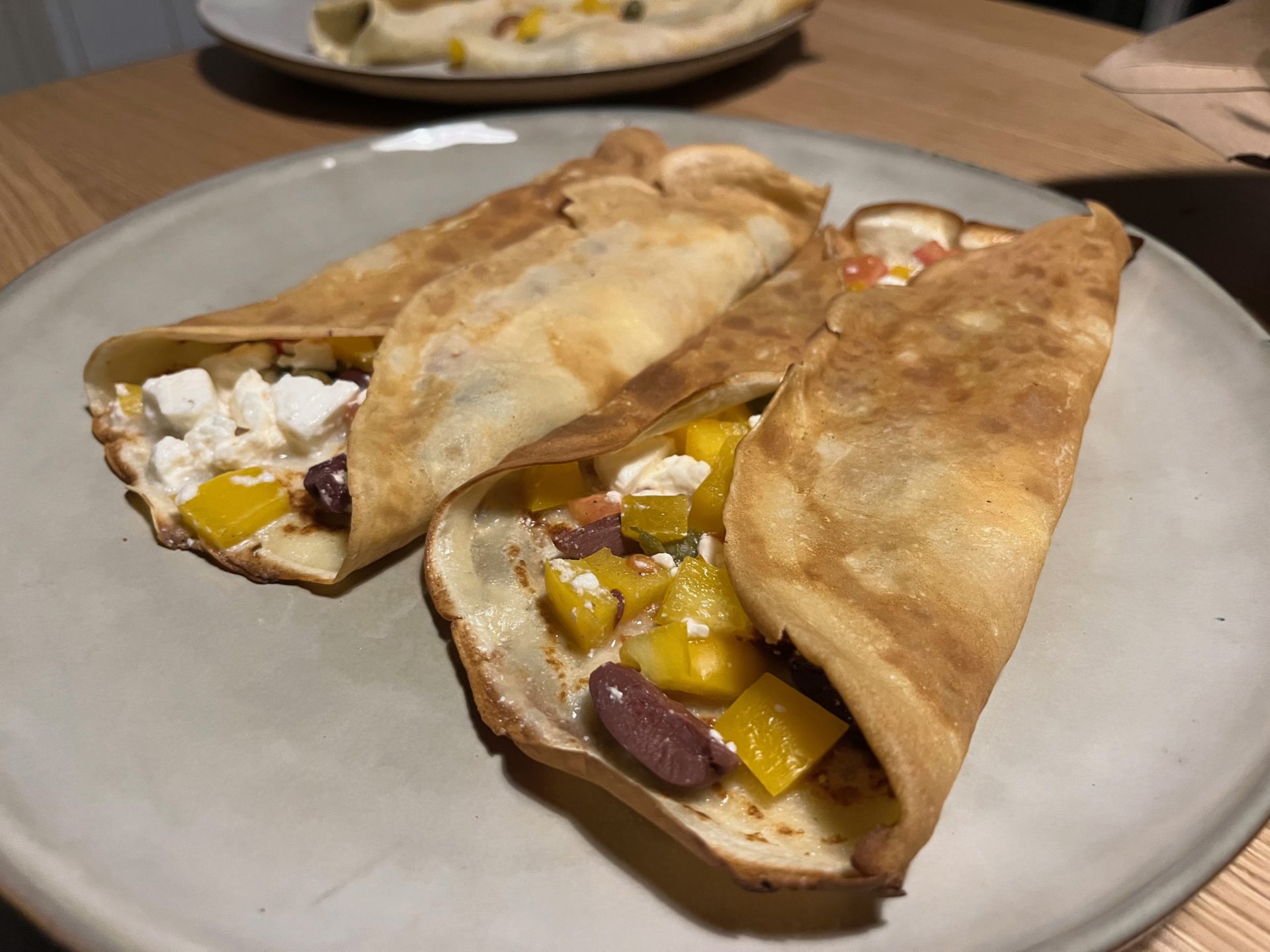 Crepes with feta cheese, tomatoes and olives