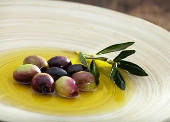 Greek olive oil and Kalamata olives in a traditional Greek dish